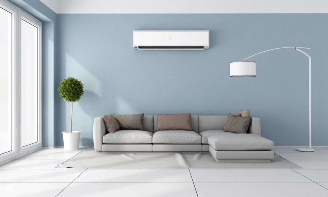 Ductless mini-split air conditioning unit mounted in a bright living room