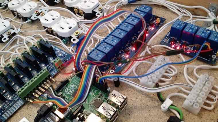 Industrial control build with relay boards, ribbon cabling and outlets on a workbench